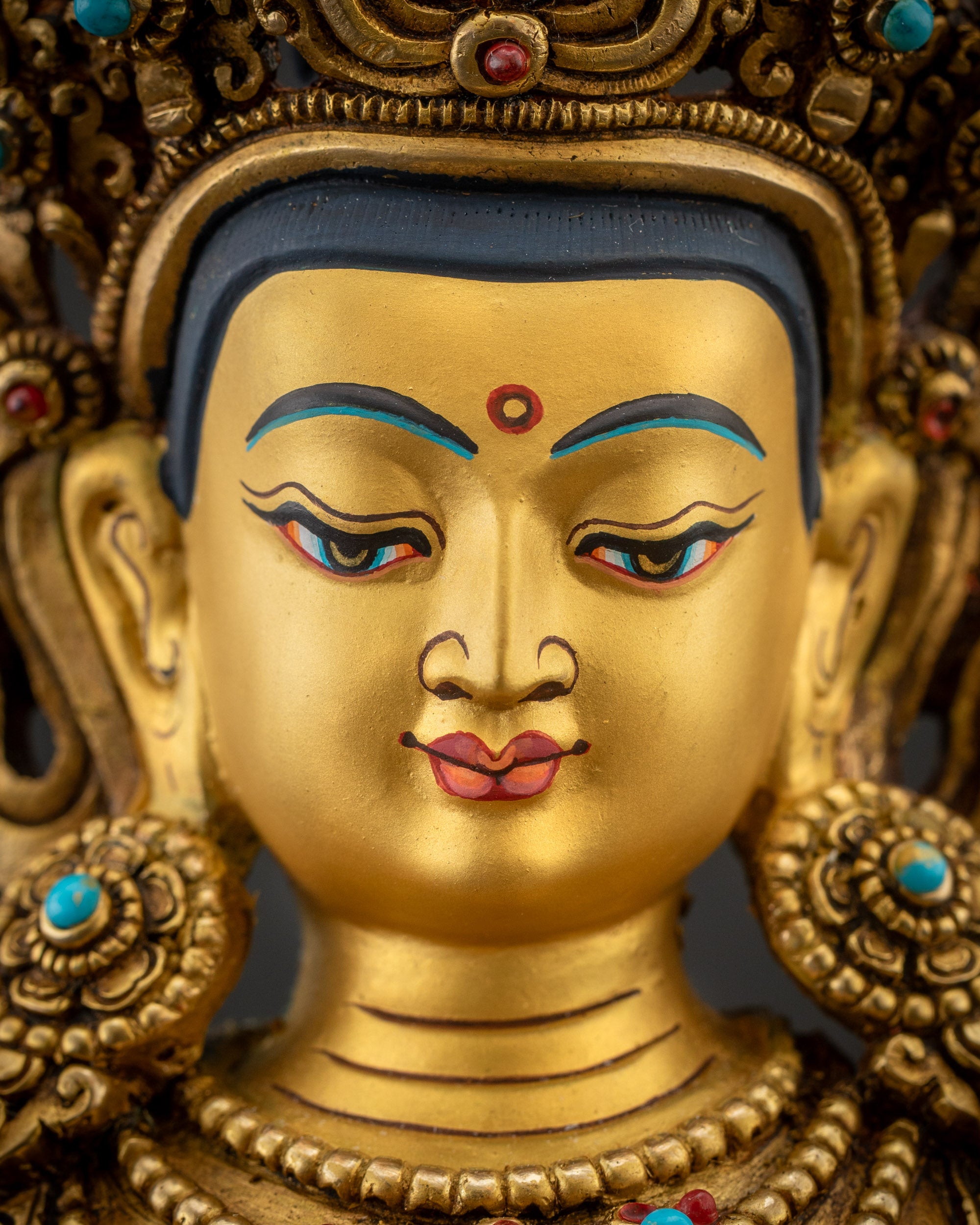 Detailed close up of Vajrasattva face showing Five-Jeweled Crown and semi-precious stones
