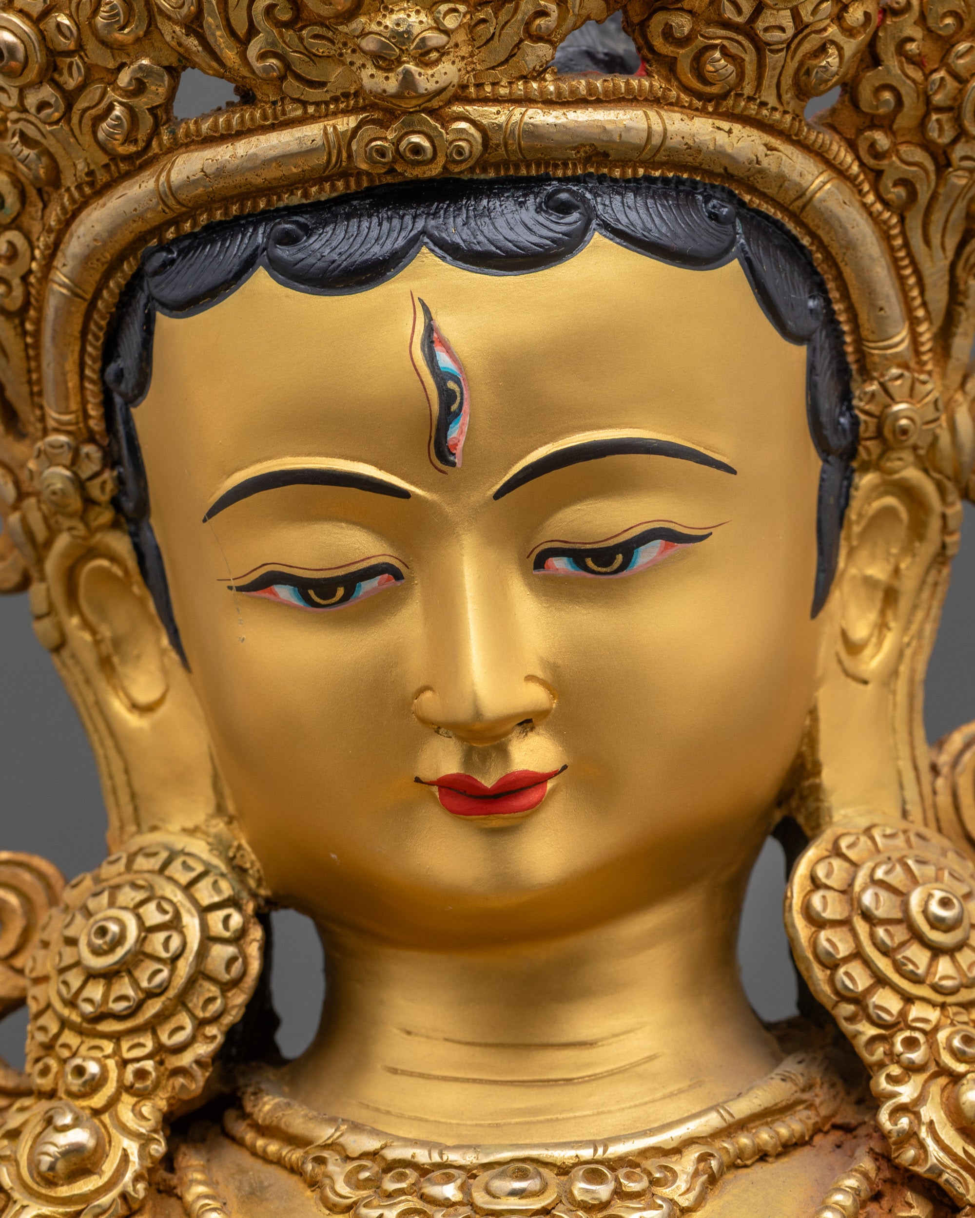Detailed close up of White Tara face showing third eye, crown, and divine expression
