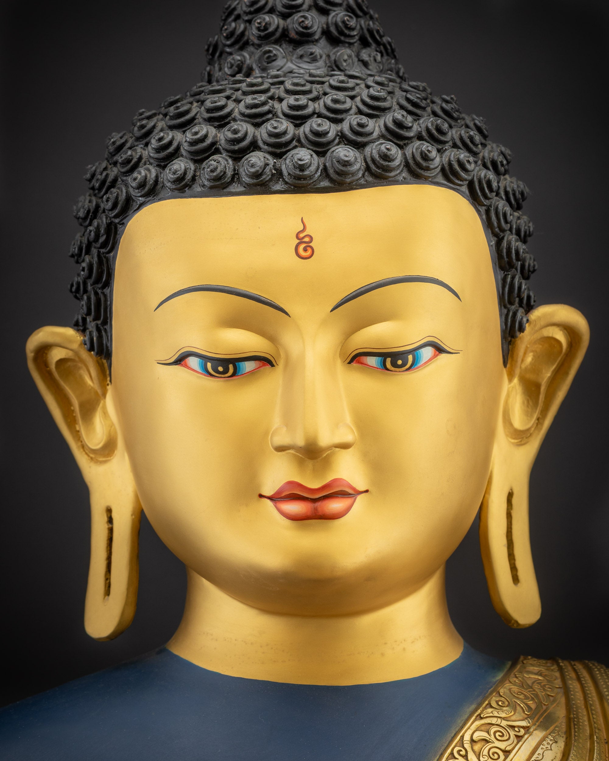 Detailed close up of face of Nepalese Healing Medicine Buddha highlighting calm serene features