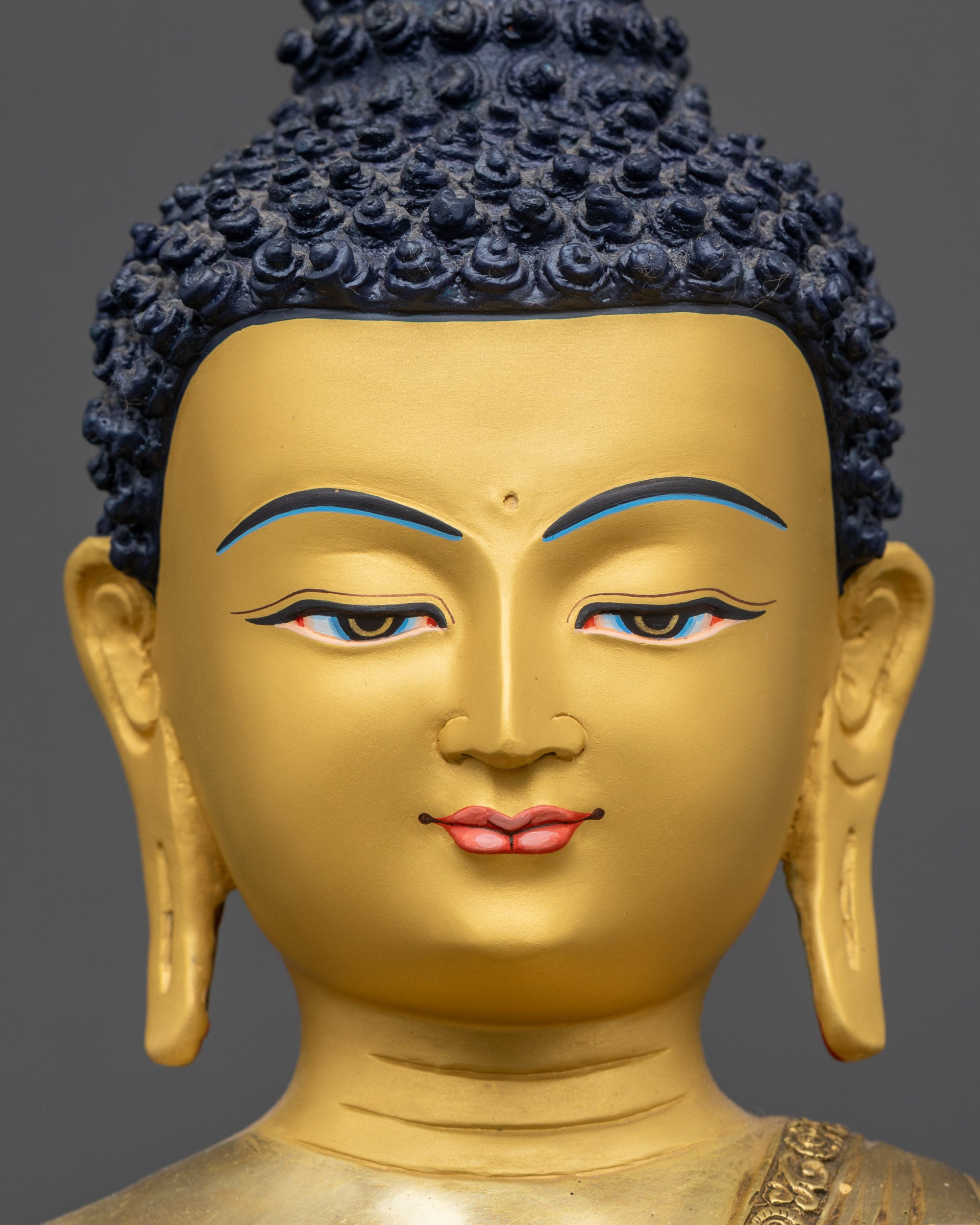 Detailed close up of face showing gold-gilded serene expression and halo

