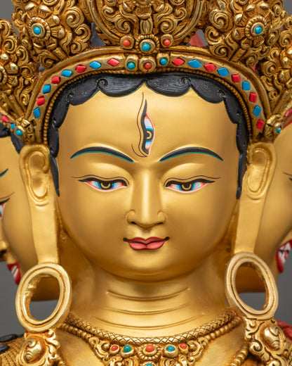 Detailed close up of gold-painted Namgyalma faces symbolizing wisdom, compassion, and all-seeing protection in Tibetan Buddhism