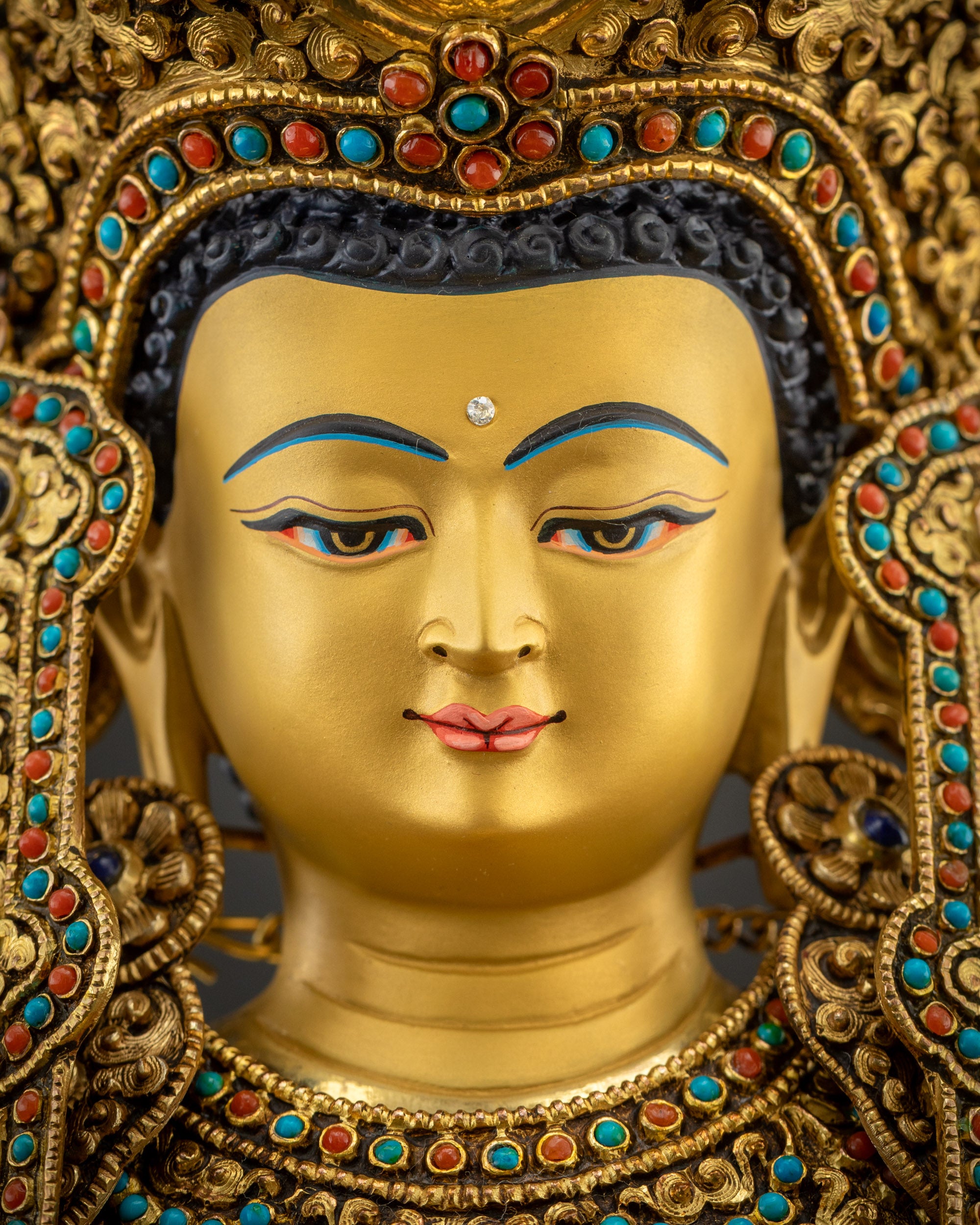 Detailed close-up of handcrafted Jowo Rinpoche Buddha gold-gilded face 