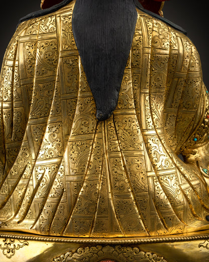 Detailed close up of kasaya robe showing intricate carving and gemstone accents
