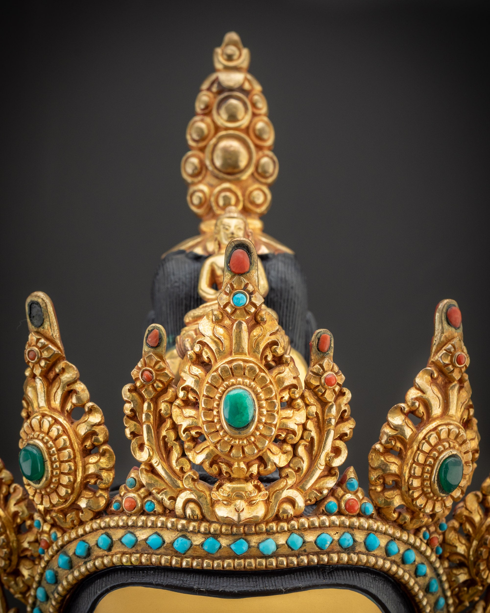 Detailed crown of Chenrezig Statue with intricate carvings and gold-gilded finish
