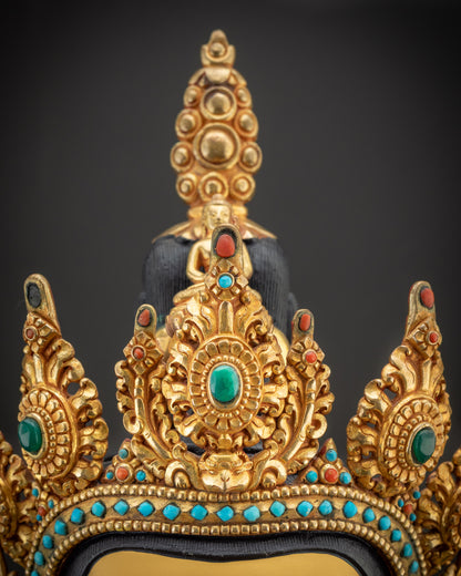 Detailed crown of Chenrezig Statue with intricate carvings and gold-gilded finish
