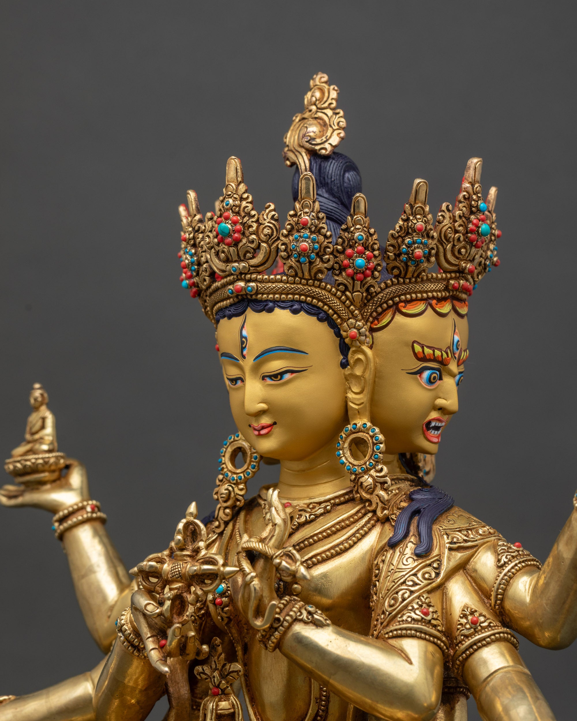 Detailed face close-up of Namgyalma, three-faced deity with gold-painted features