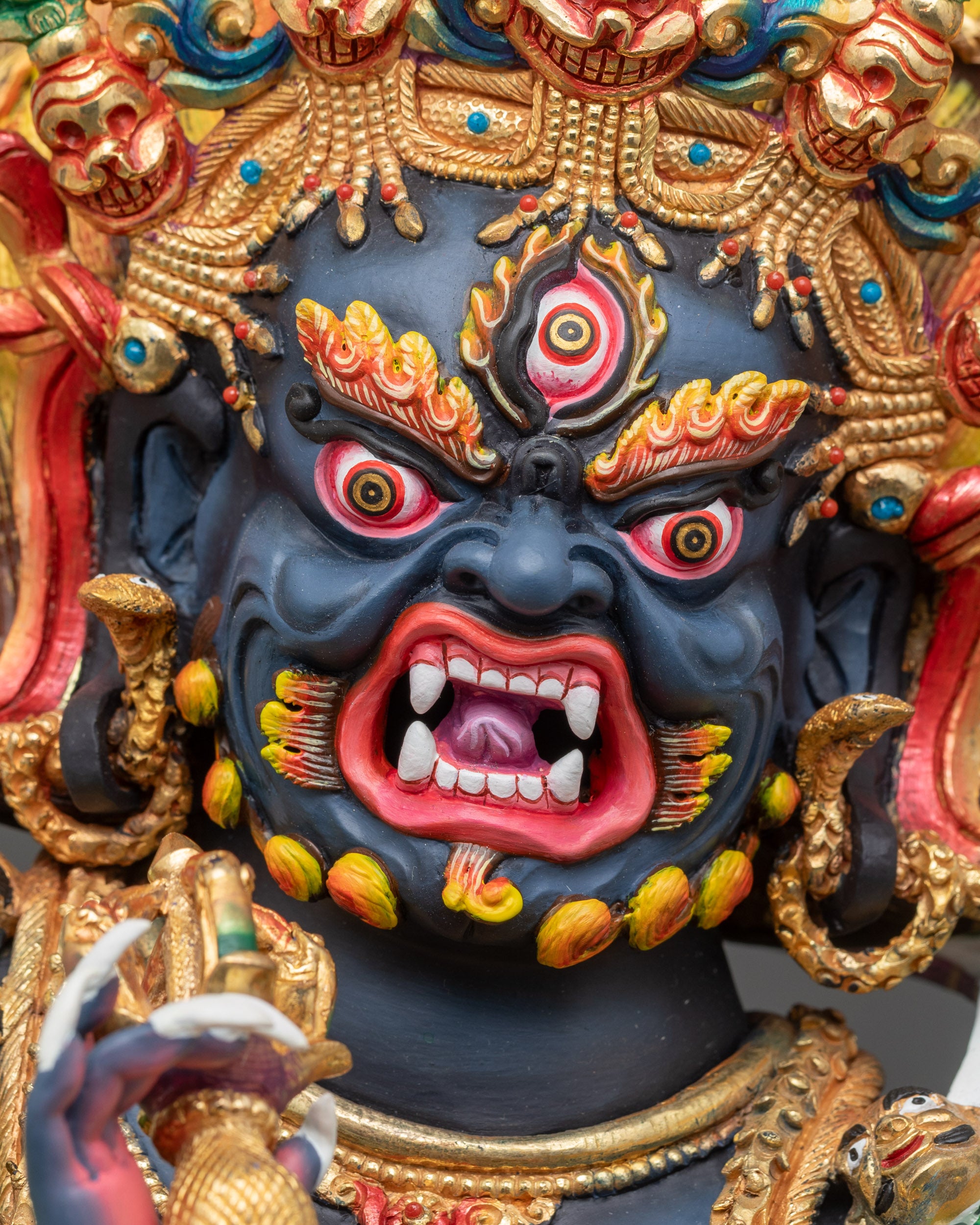 Detailed face close-up of Six-Armed Mahakala Statue with wrathful expression and third eye
