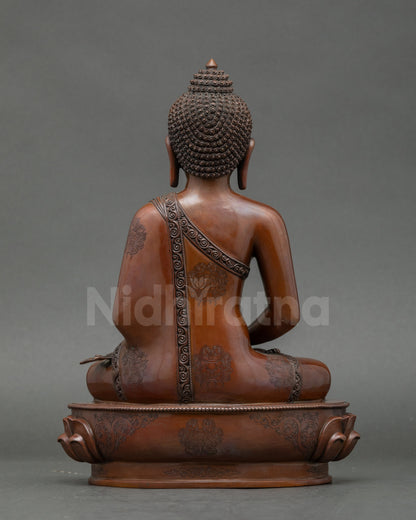Detailed face close-up of gold-gilded Amitabha Buddha meditation idol from Nepal