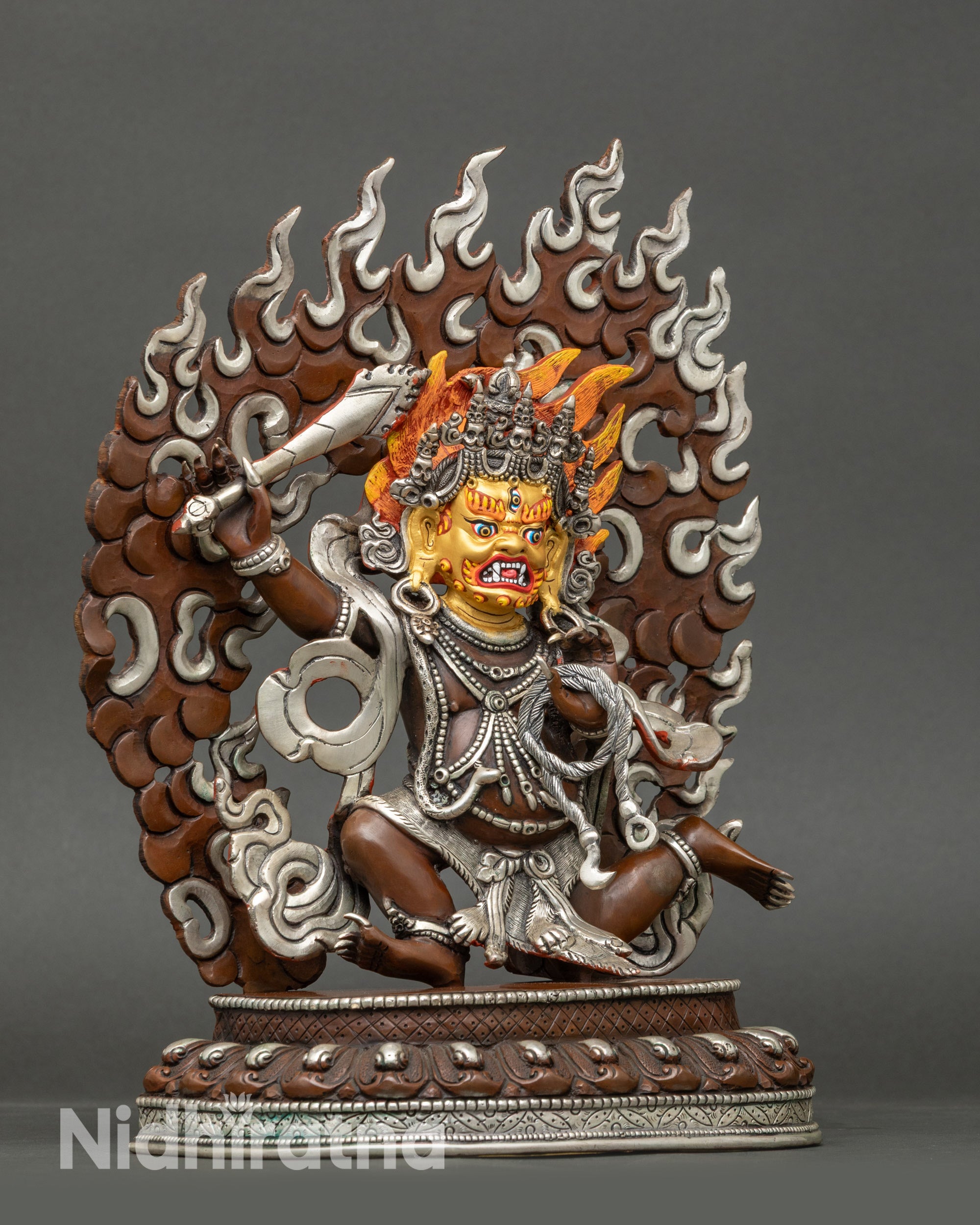 Detailed face of Achala Buddhist Protector Figurine, 24K gold-painted, Newari artisan craftsmanship