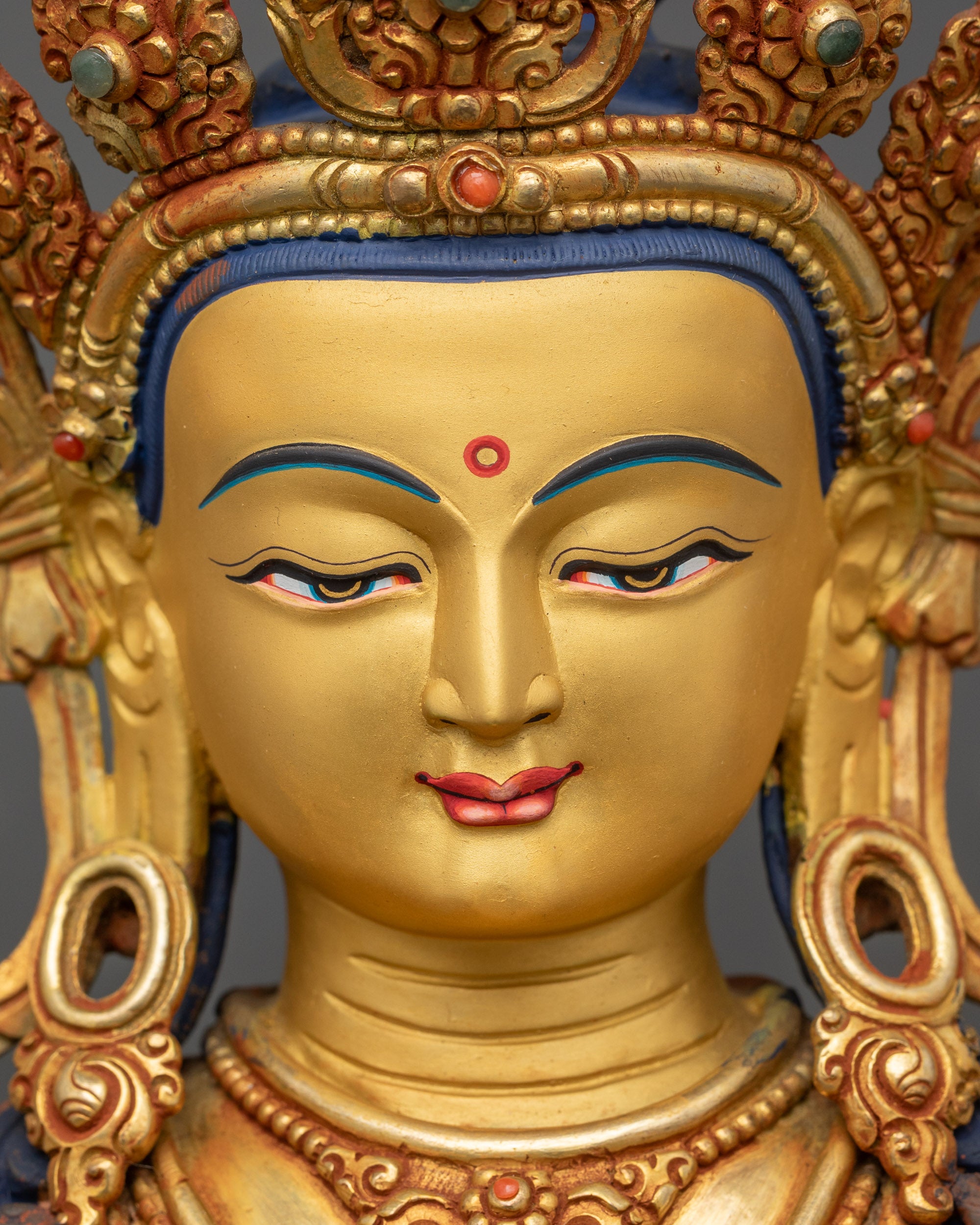 Detailed face of Amitayus Buddha with peaceful expression and radiant gold finish
