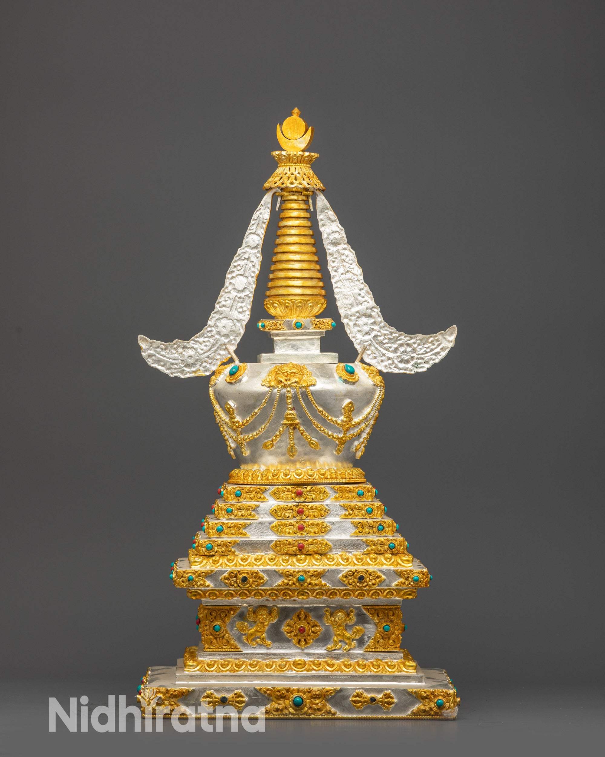 Detailed gold-plated motifs and filigree work on Tibetan Buddhist Stupa
