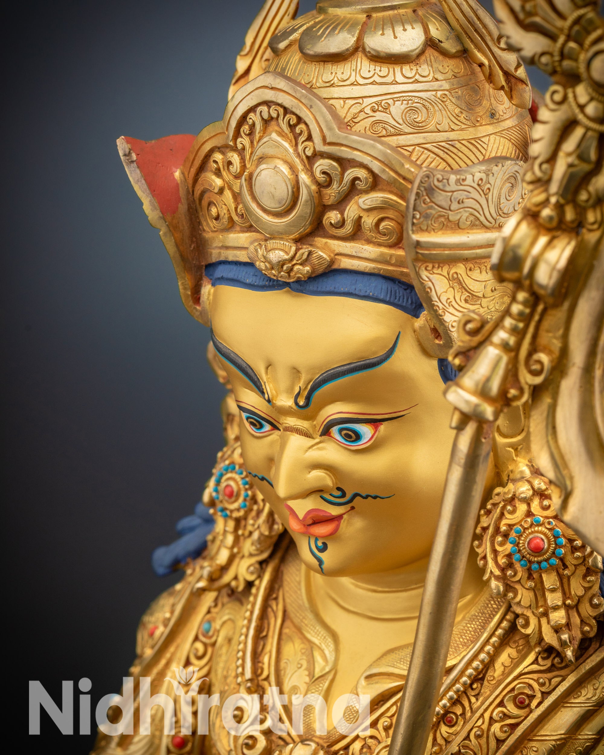 Detailed high-angle shot showing floral carvings on Guru Rinpoche statue