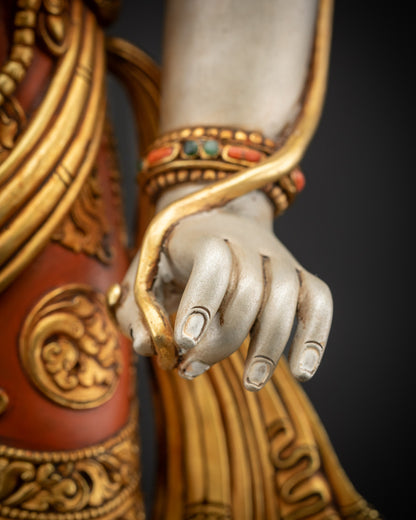 Detailed holding stem close up showing Utpala flower in Lokeshvara’s hand