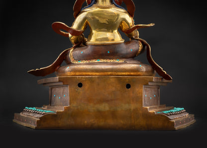 Detailed landscape back shot Dzambhala statue on lotus throne showing carved robe details