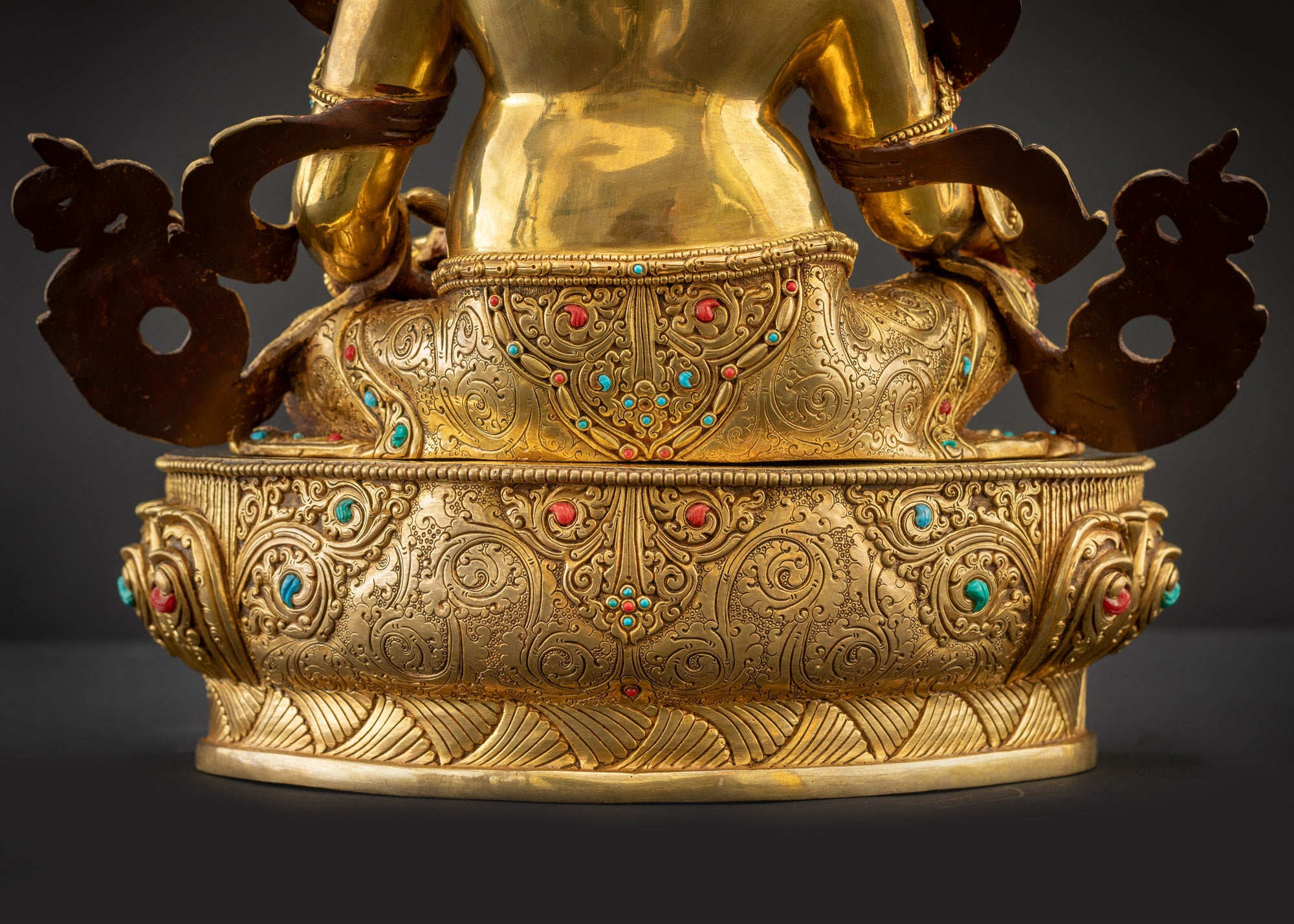 Detailed landscape back view of statue seated on lotus showing carved robe folds
