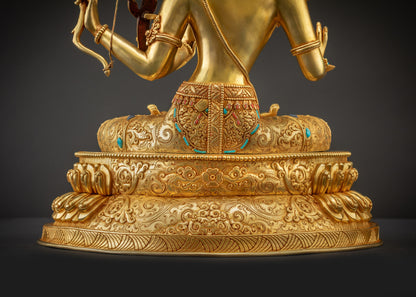Detailed landscape shot back view of Maha Manjushri statue on lotus seat with glowing textures.
