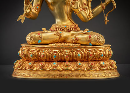 Detailed landscape shot front Maha Manjushri Statue on lotus pedestal with radiant gold detailing
