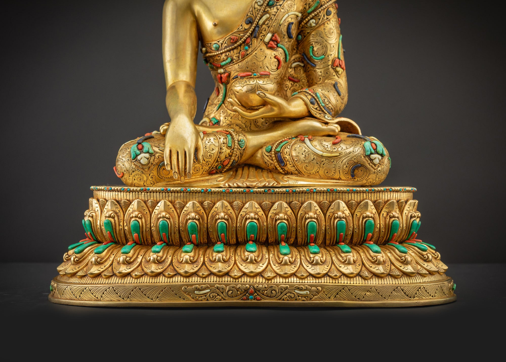 Detailed landscape shot front view of statue seated on lotus seat gold gilded and radiant
