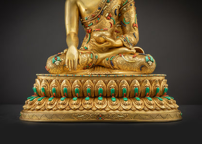 Detailed landscape shot front view of statue seated on lotus seat gold gilded and radiant
