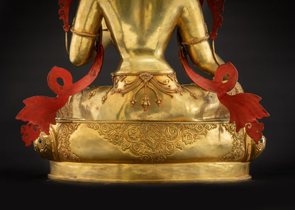 Detailed landscape shot of Mother Green Tara statue seated on lotus seat back showing robe and pedestal