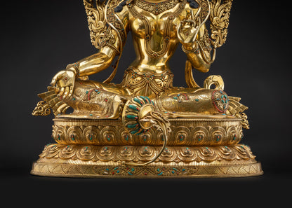 Detailed landscape shot of statue seated on lotus seat front Green Tara full front sacred altar
