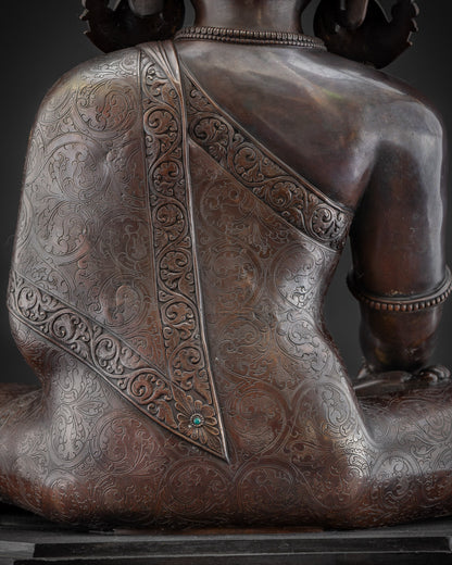 Detailed shot carved Buddhist monk’s robe on oxidized Shakyamuni Buddha artwork
