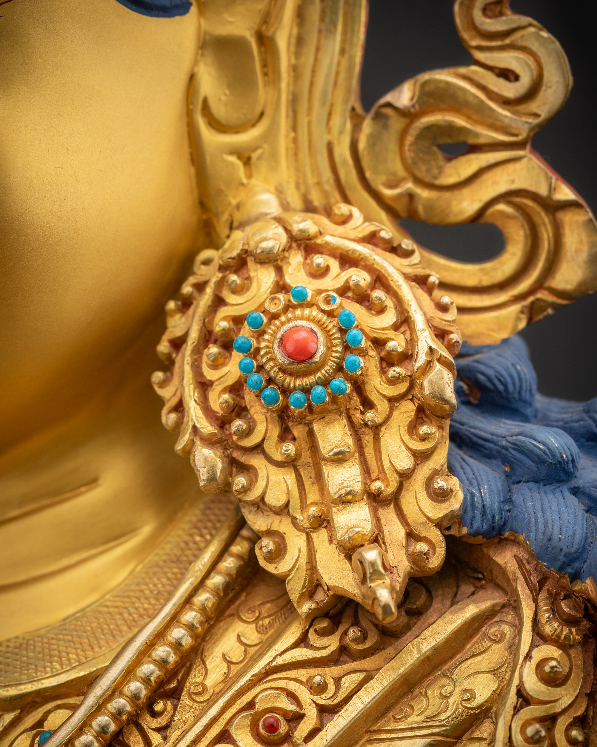 Detailed shot of Guru Rinpoche earrings with gold fire-gilded detailing