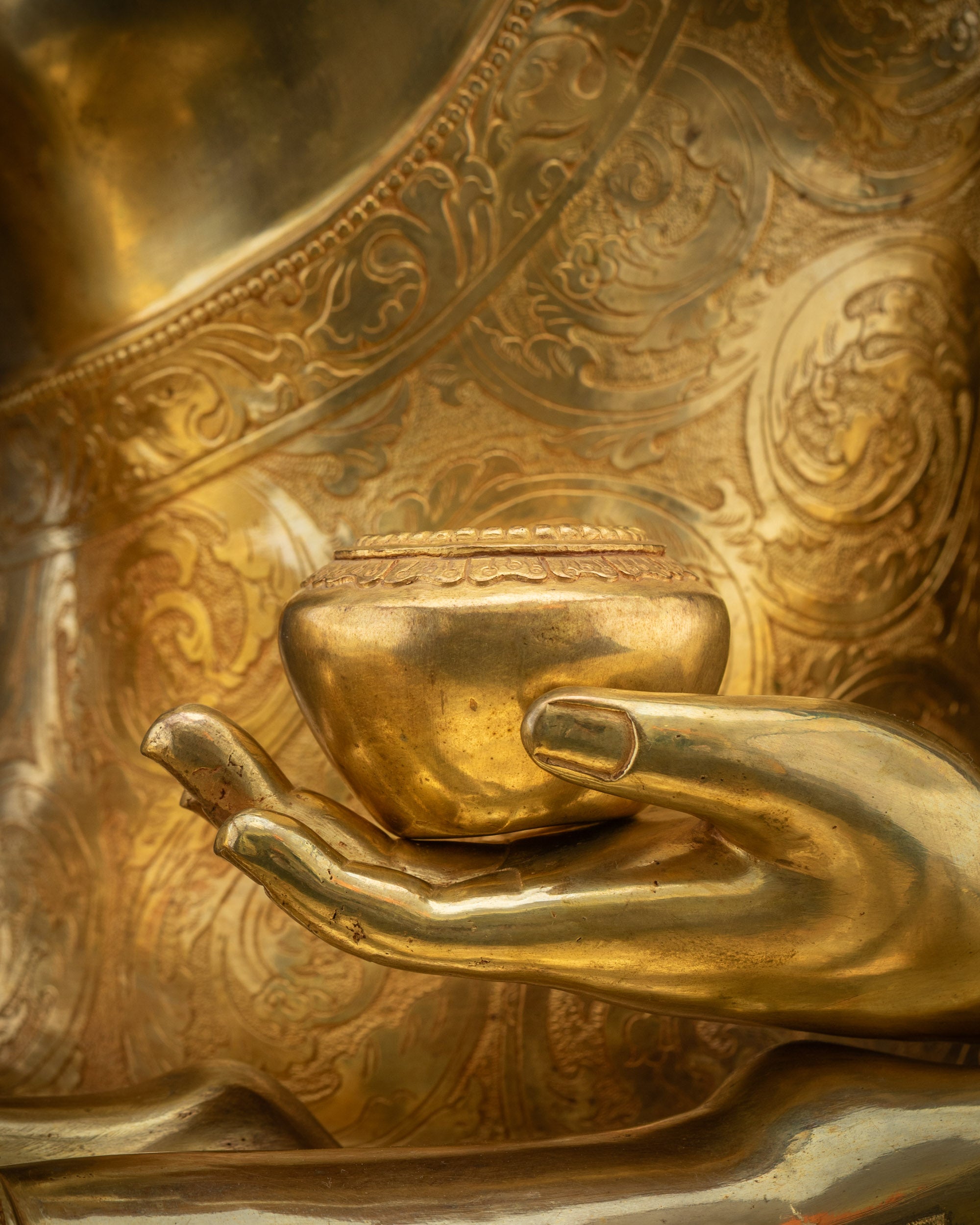 Detailed shot of Patra bowl on Buddha Shakyamuni statue in meditation pose