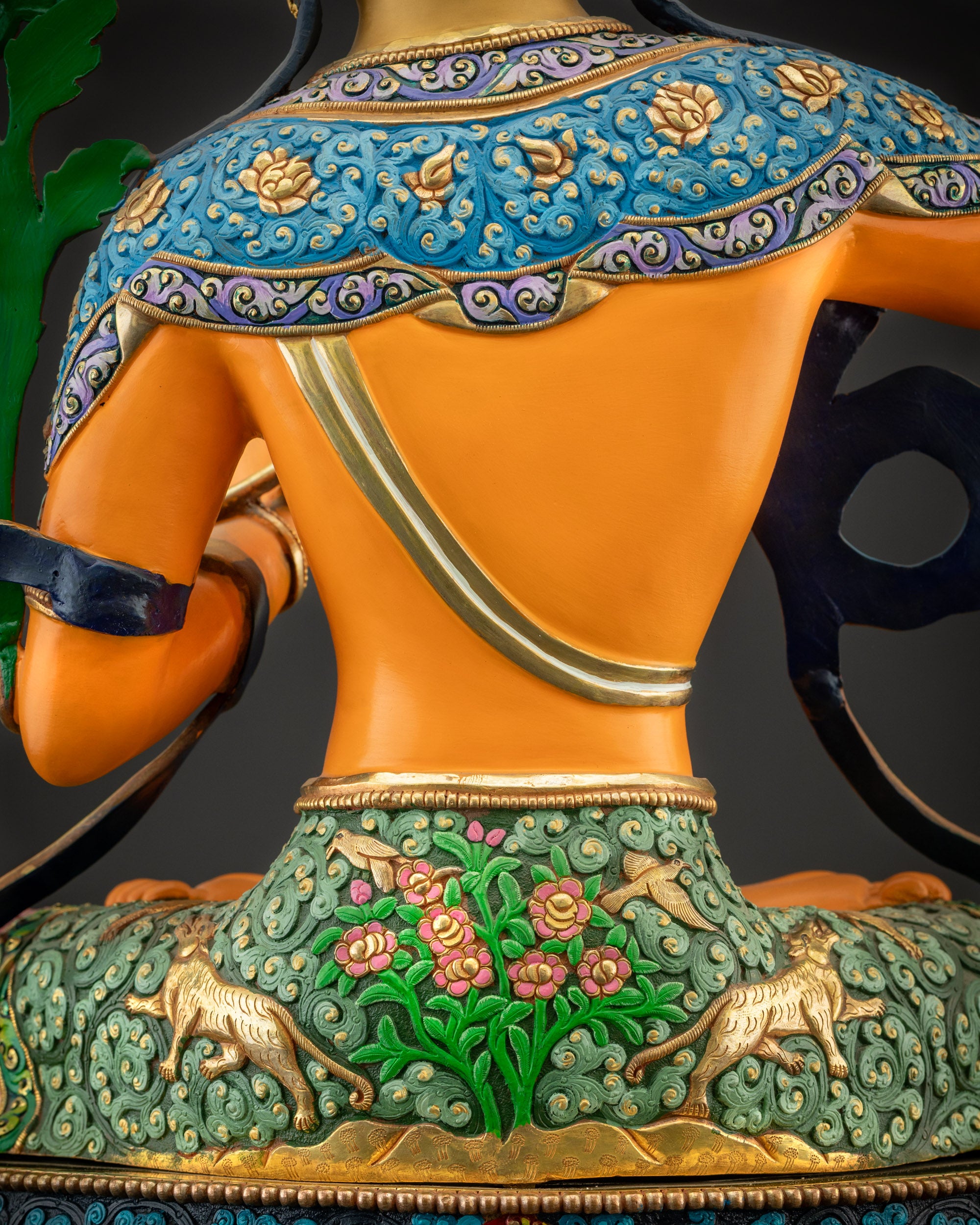 Detailed shot of back of Manjushri statue showing carved robes and lotus base
