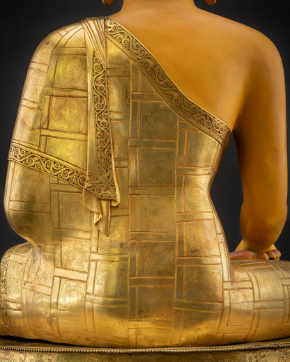 Detailed shot of fire gold-gilded robe Shakyamuni Buddha Siddhartha Gautama
