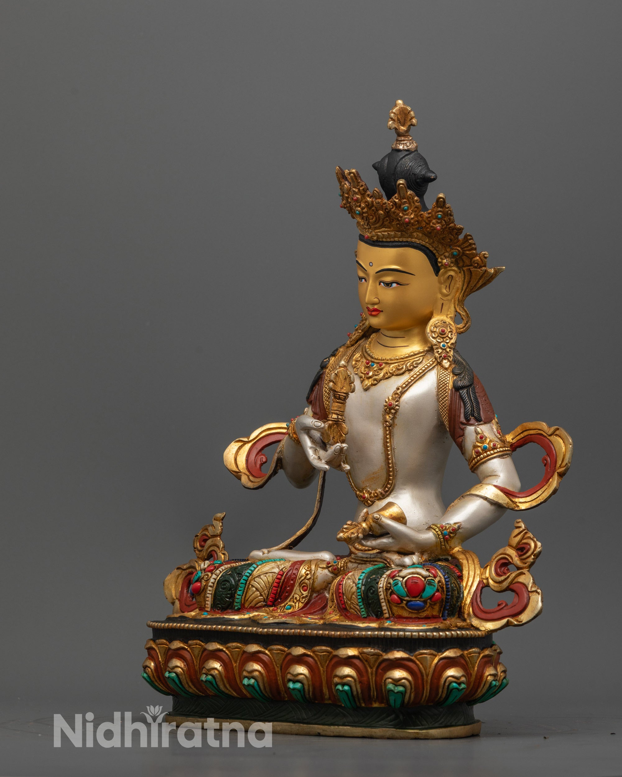 Detailed shot of five-jewel crown and intricate lotus base on 24k gold-gilded
