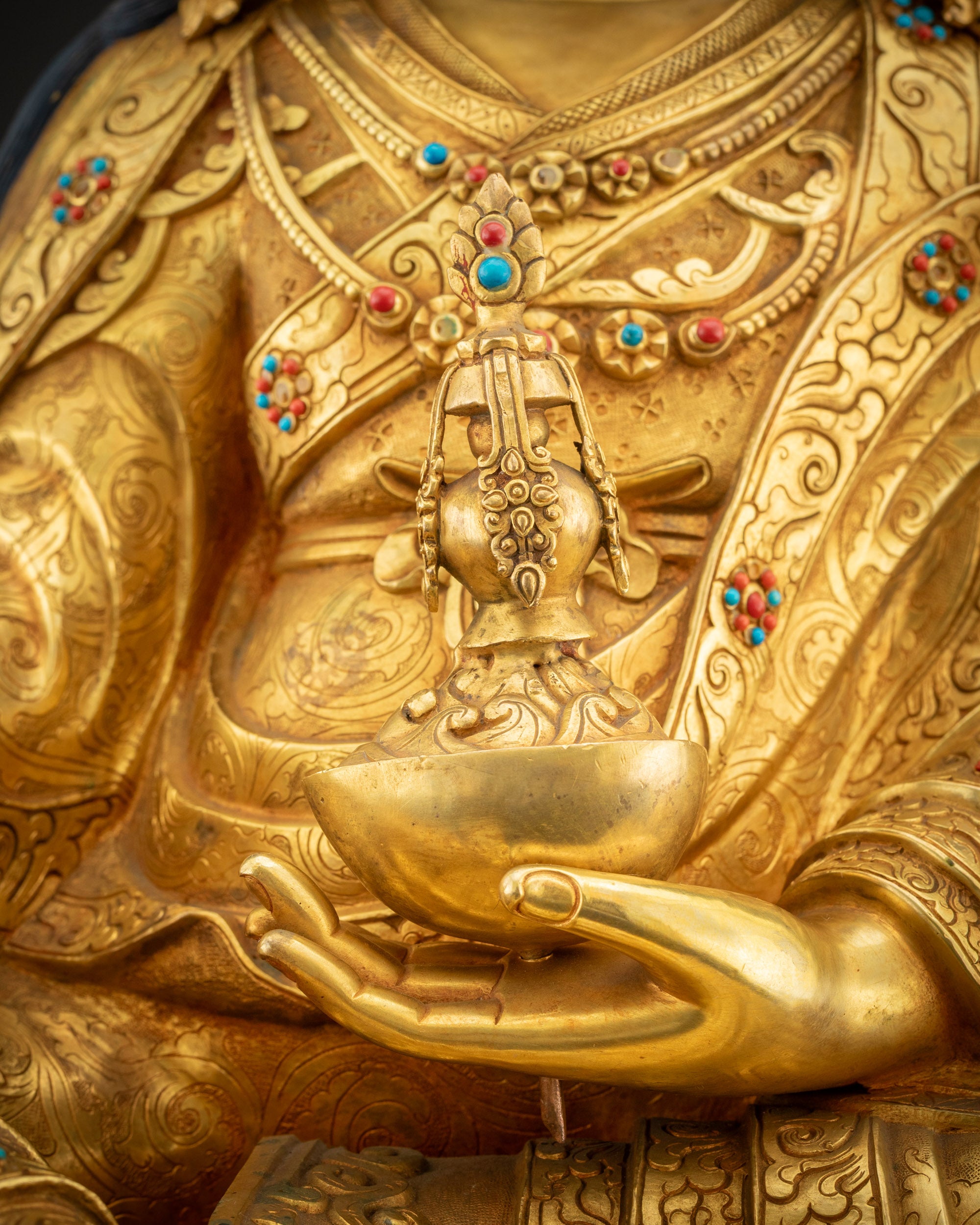 Detailed shot of kapala skull cup with gilded and jeweled accents
