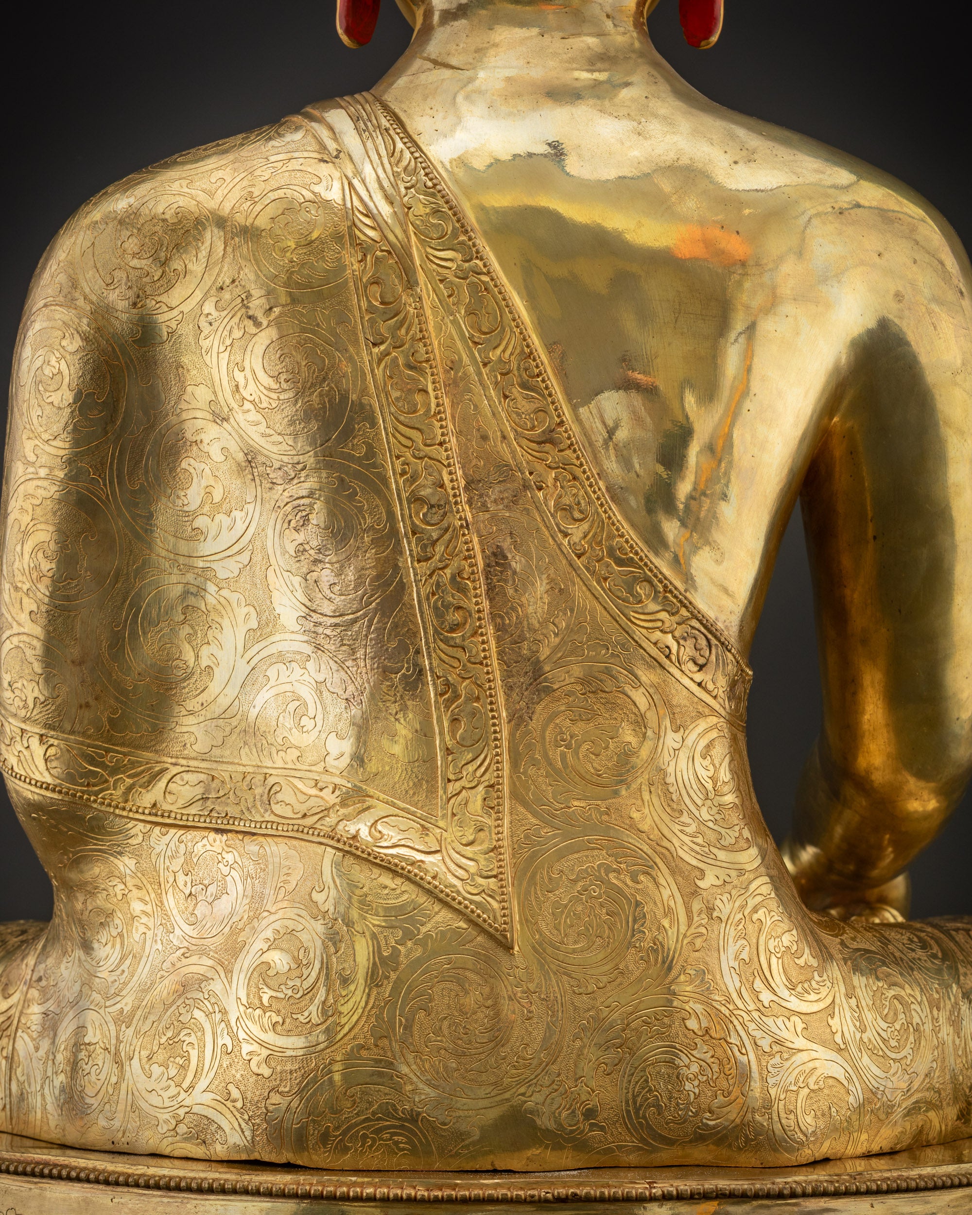 Detailed shot of monk’s robe carved patterns on Buddha Shakyamuni statue