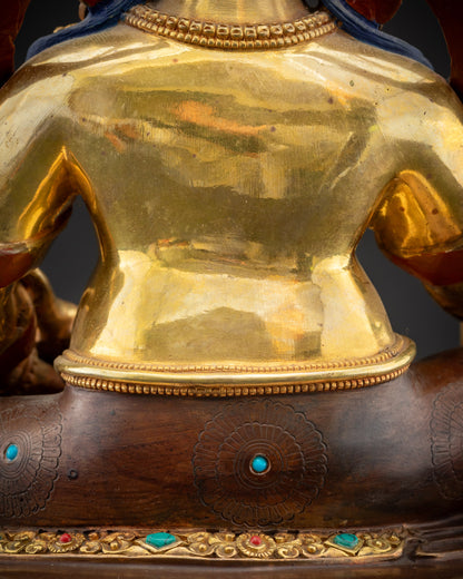 Detailed shot of robe and semi-precious stones on Dzambhala gold-gilded statue