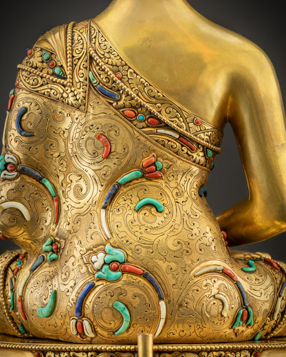 Detailed shot of robe and stones on Amitabha Buddha, floral motifs and gemstones
