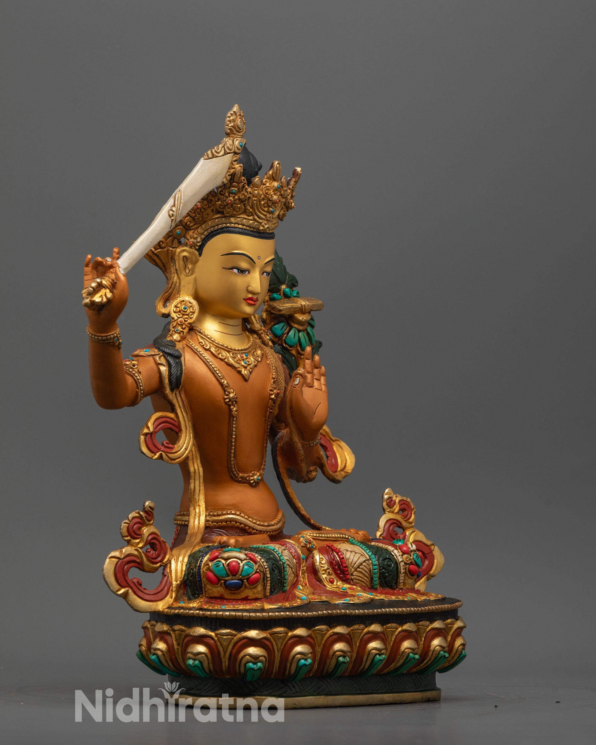 Detailed shot of semi-precious stone adornments on copper-based Manjushri Statue