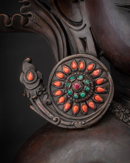 Detailed shot of semi-precious stone earrings on oxidized Crowned Shakyamuni Buddha statue