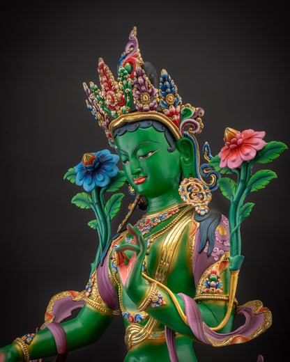 Detailed side Green Tara statue profile showing flowing robes and lotus base