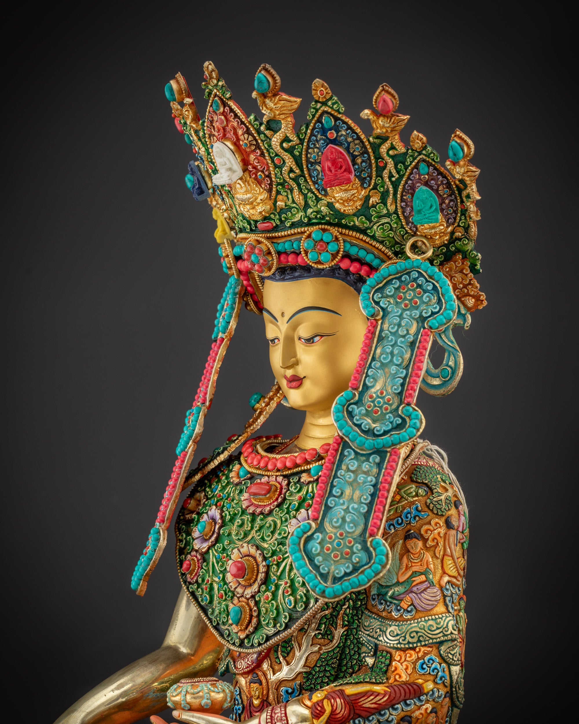 Detailed side Jowo Rinpoche Shakyamuni statue showing robe carvings and gem inlays

