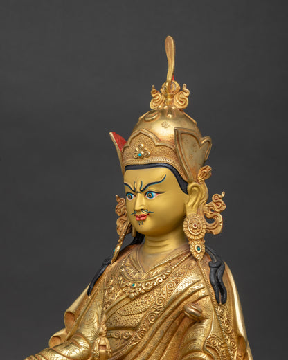 Detailed side close-up of Guru Rinpoche statue – copper and gold Himalayan meditation statue showing ornate robe folds