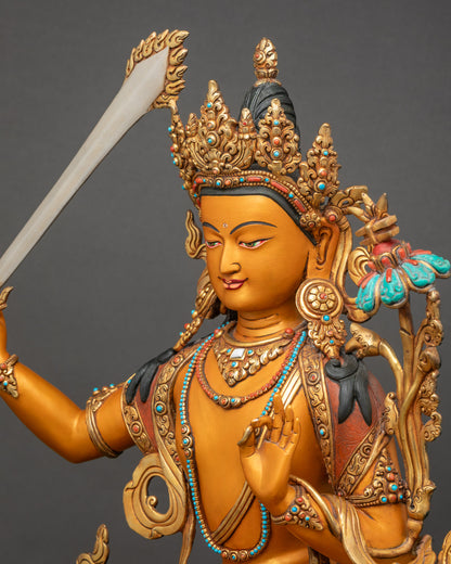 Detailed side close-up of Manjushri statue showing gold-plated swirling robe craftsmanship