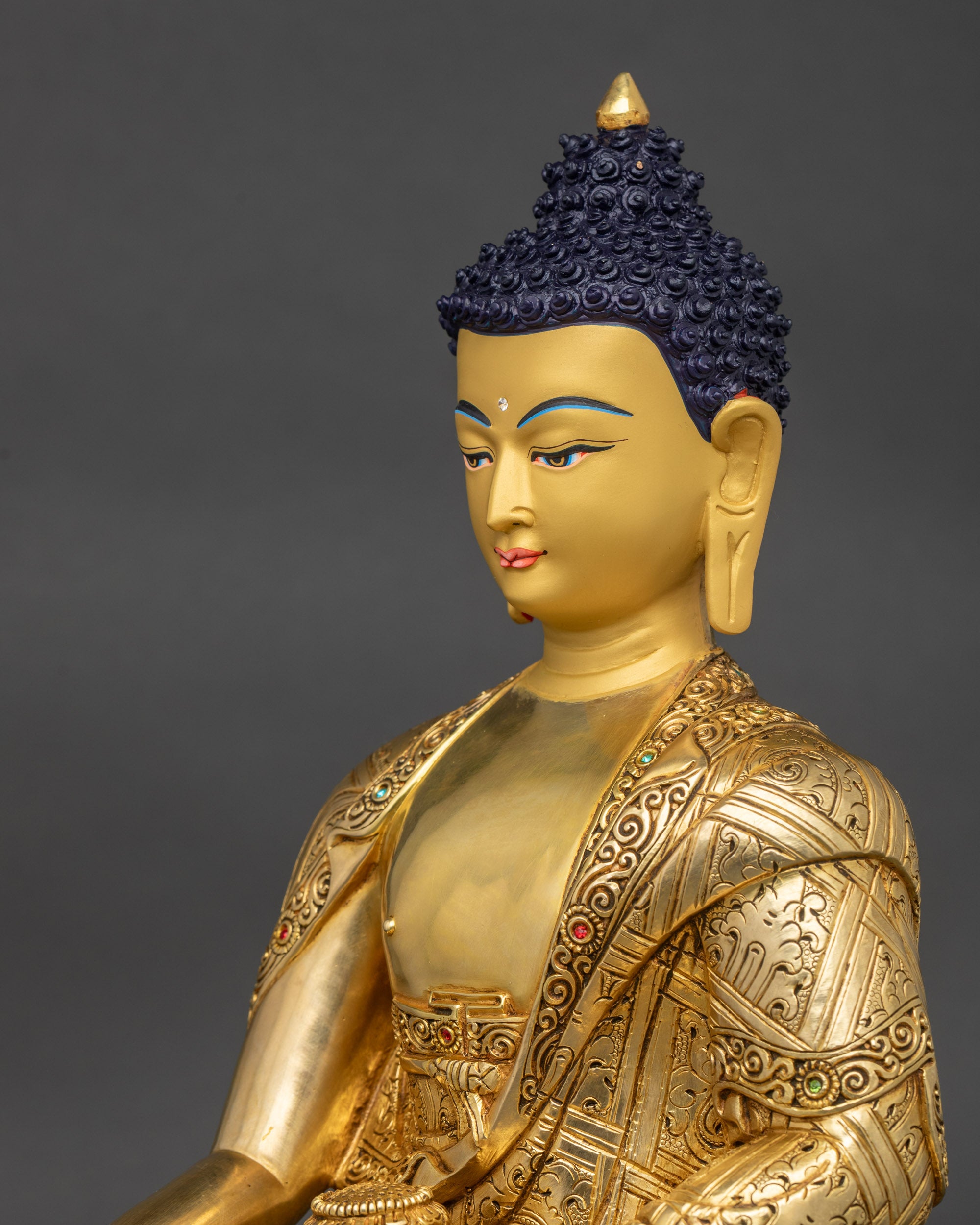 Detailed side close-up of Shakyamuni Buddha statue highlighting floral motifs on robe