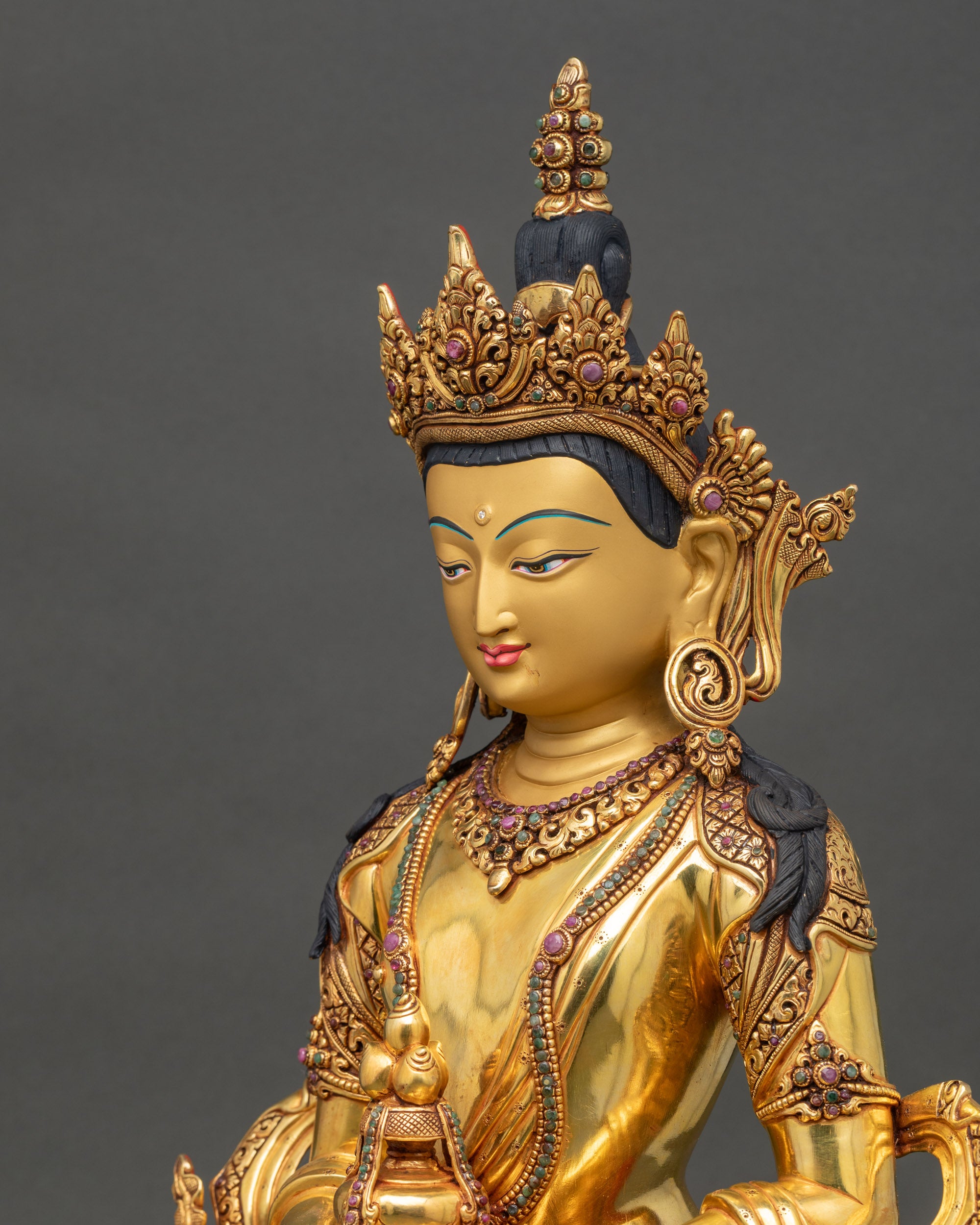 Detailed side close up Amitayus statue highlighting flowing robes and jewelry carvings