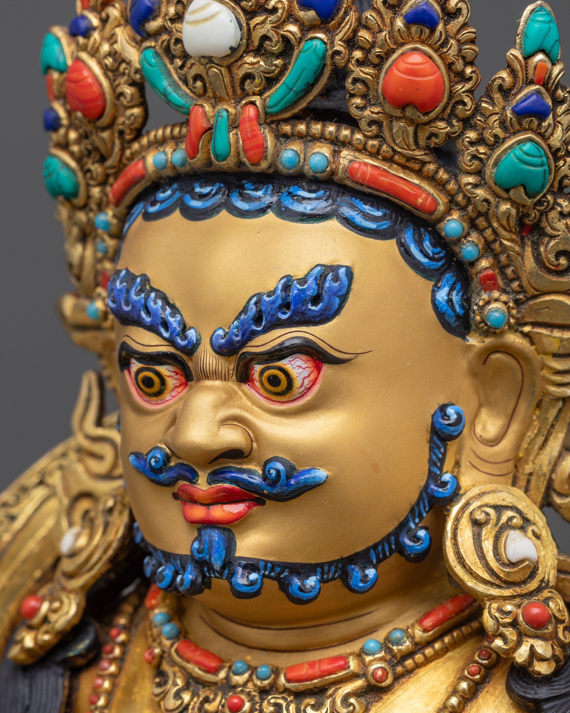 Detailed side close up Dzambhala crown and jewel-embedded ornaments