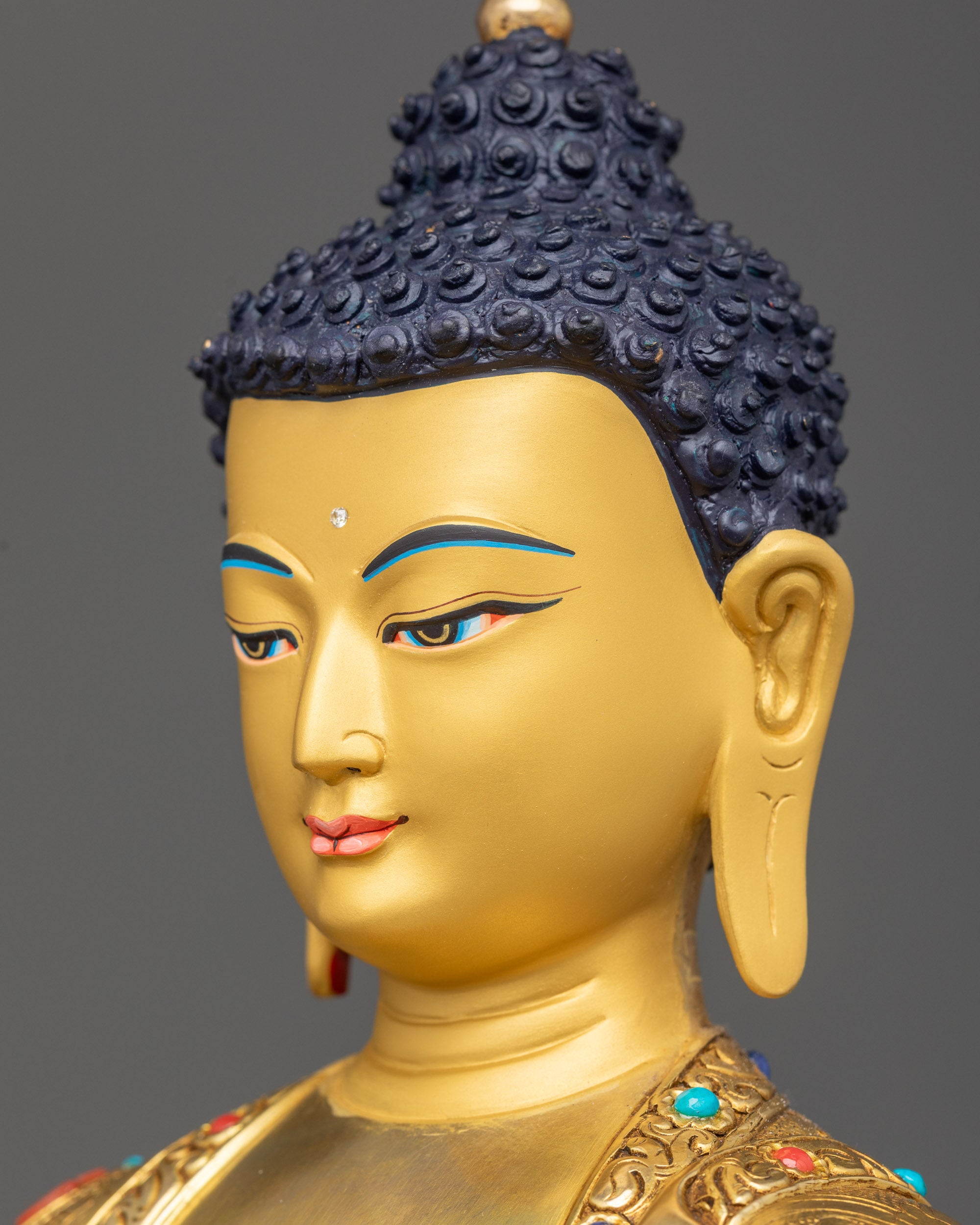 Detailed side close up face Shakyamuni Buddha calm expression with gold gilding details
