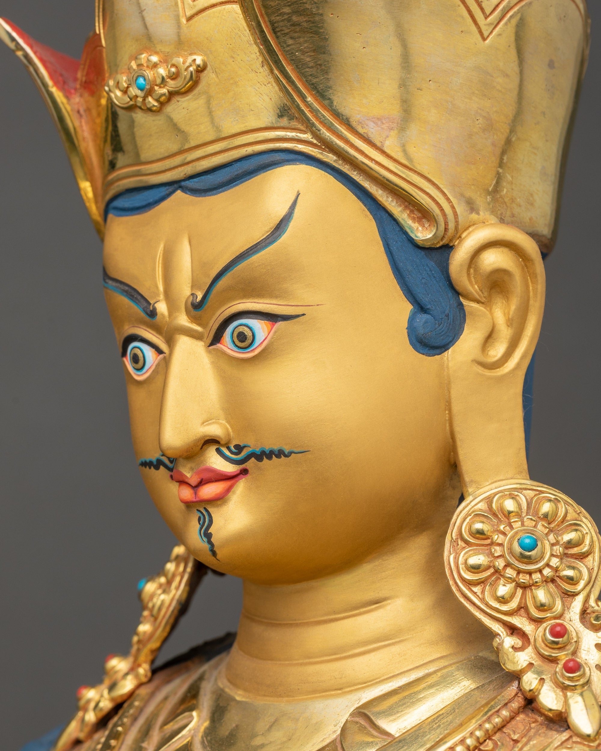 Detailed side close-up face of the Guru Rinpoche Statue showing Semi-wrathful expression