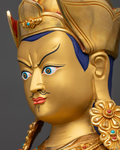 Detailed side close up face of Guru Rinpoche statue showing intricate facial features
