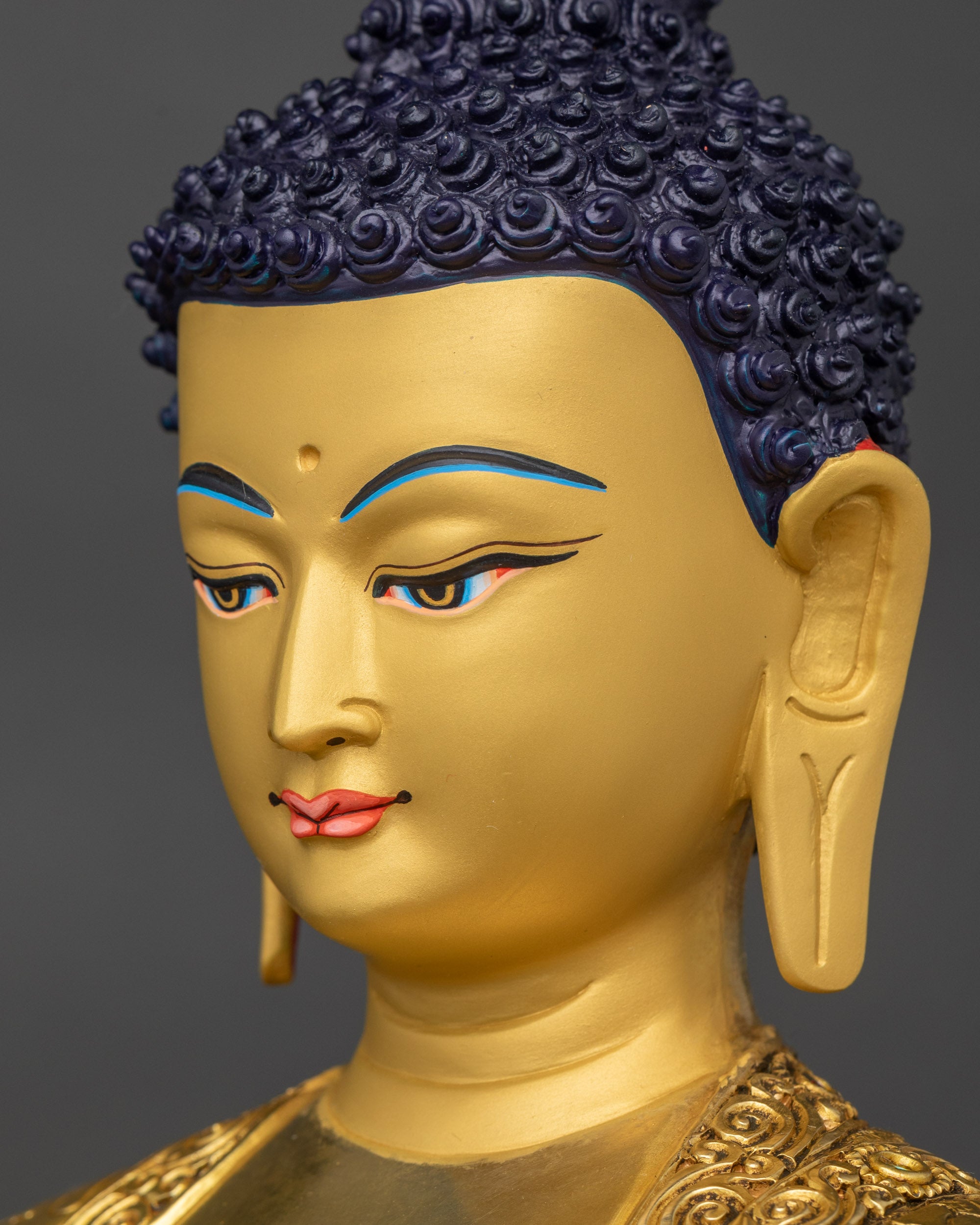 Detailed side close up face of Medicine Buddha with intricate floral motif robe carvings