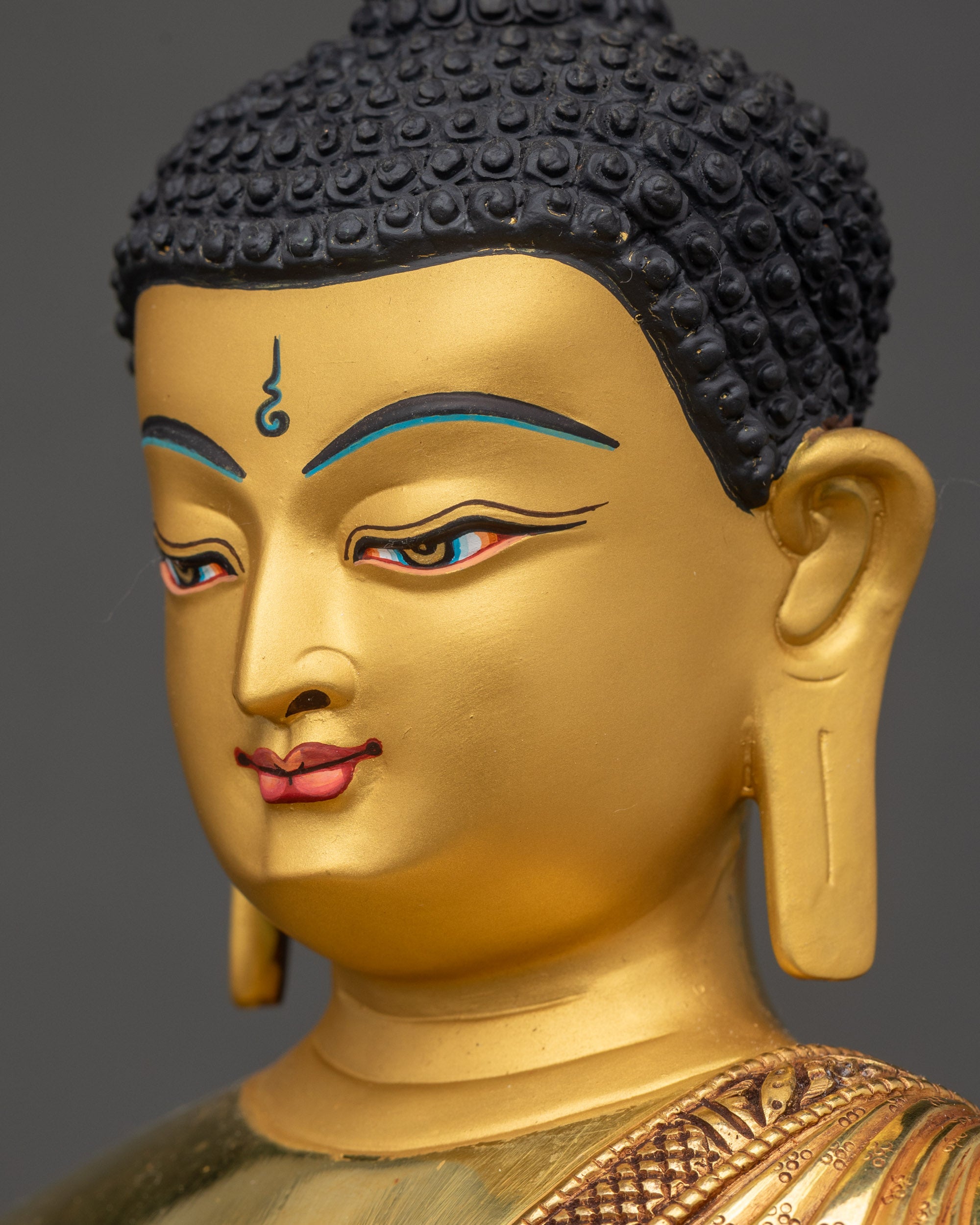 Detailed side close up face of Shakyamuni Buddha with meditative expression in gold