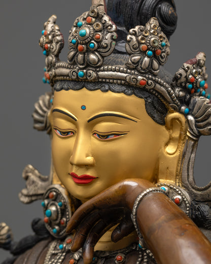 Detailed side close up of Chenrezig face showing gold-gilded features and serene expression